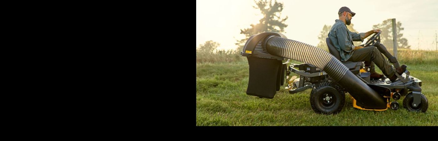 man on cub cadet zero-turn mower cutting grass